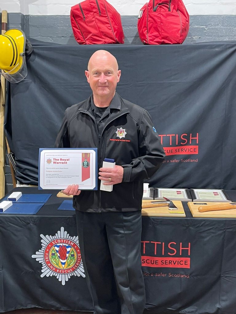 Andy receiving his medal for Royal Warrant for Fire and Rescue long service and good conduct