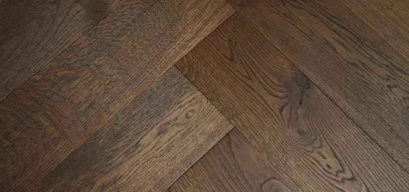 Grande Parquet Brushed Double Smoked Ebony Oak Flooring laid in a herringbone pattern