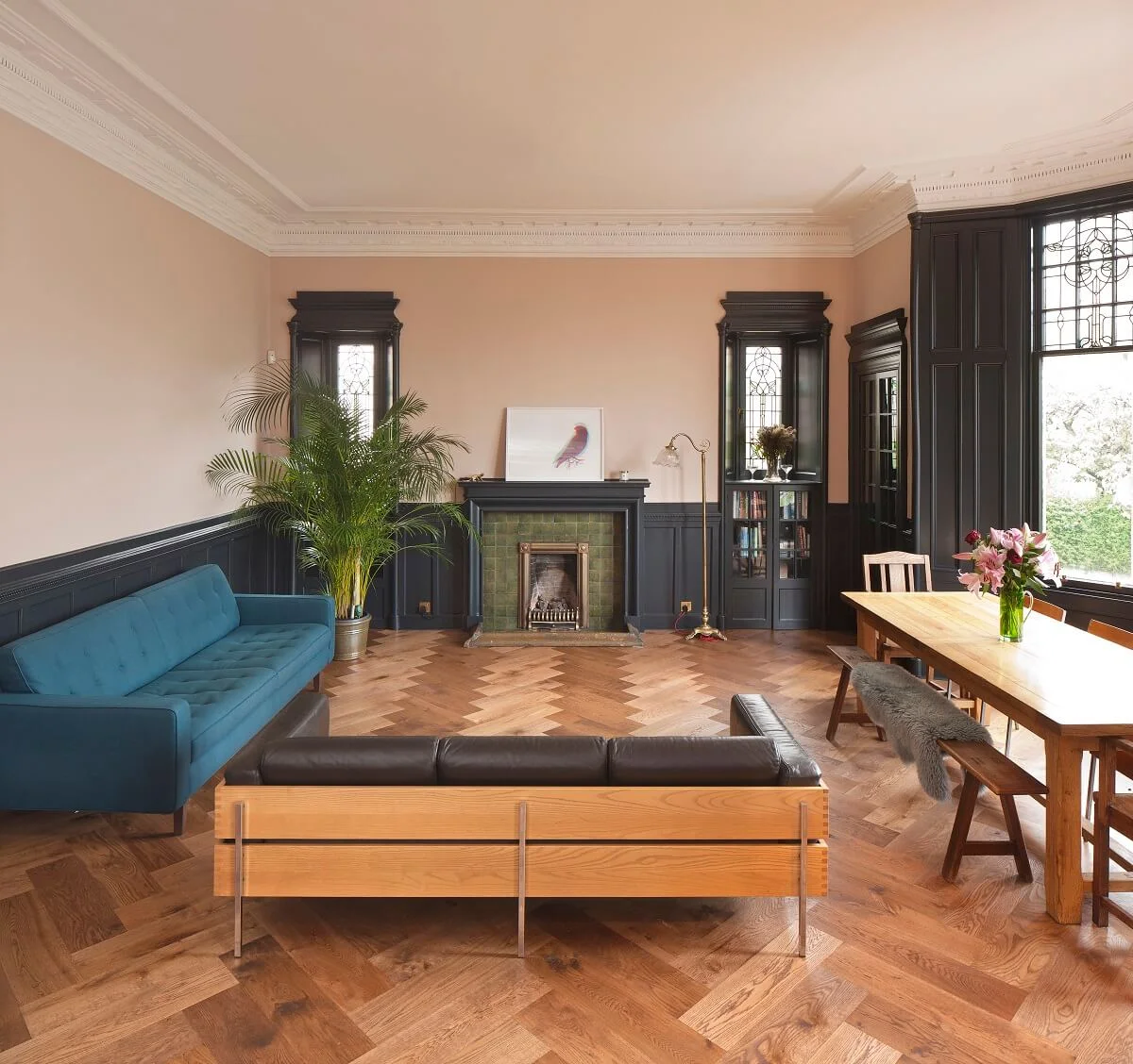 Russwood European Oak Flooring in Amber in a living room with a sofa and fireplace.
