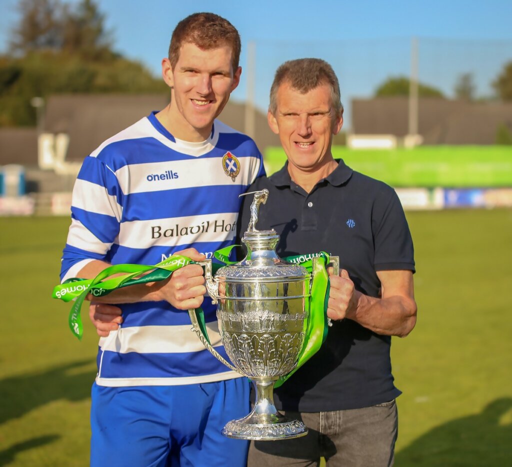 Fraser and Kenneth Mackintosh holding the Camanachd cup.