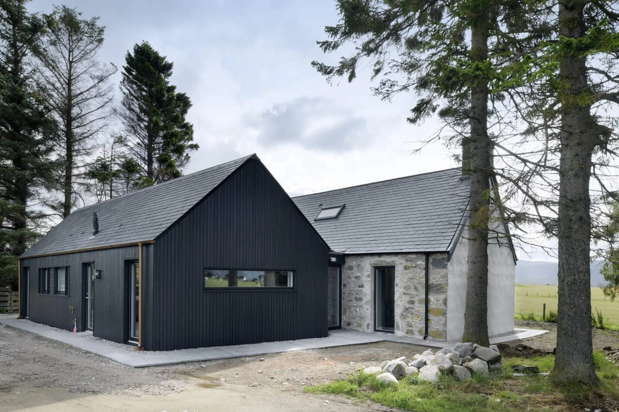 Strone Cottage timber clad in brushed Thermopine® Cladding in profile RW014 coated black by Loader Monteith Architects