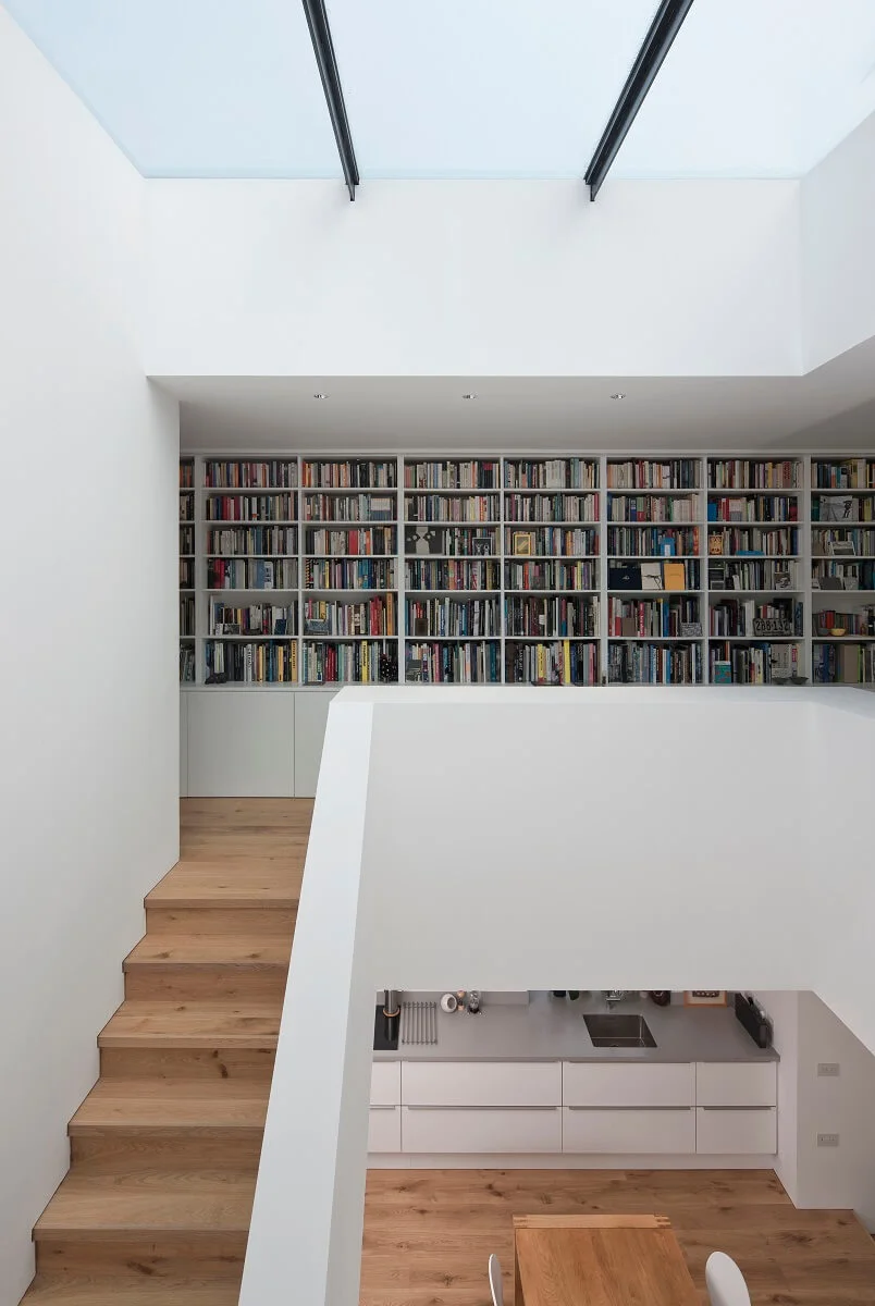 Russwood European Oak Flooring in Natural in a room with a bookcase and white walls.