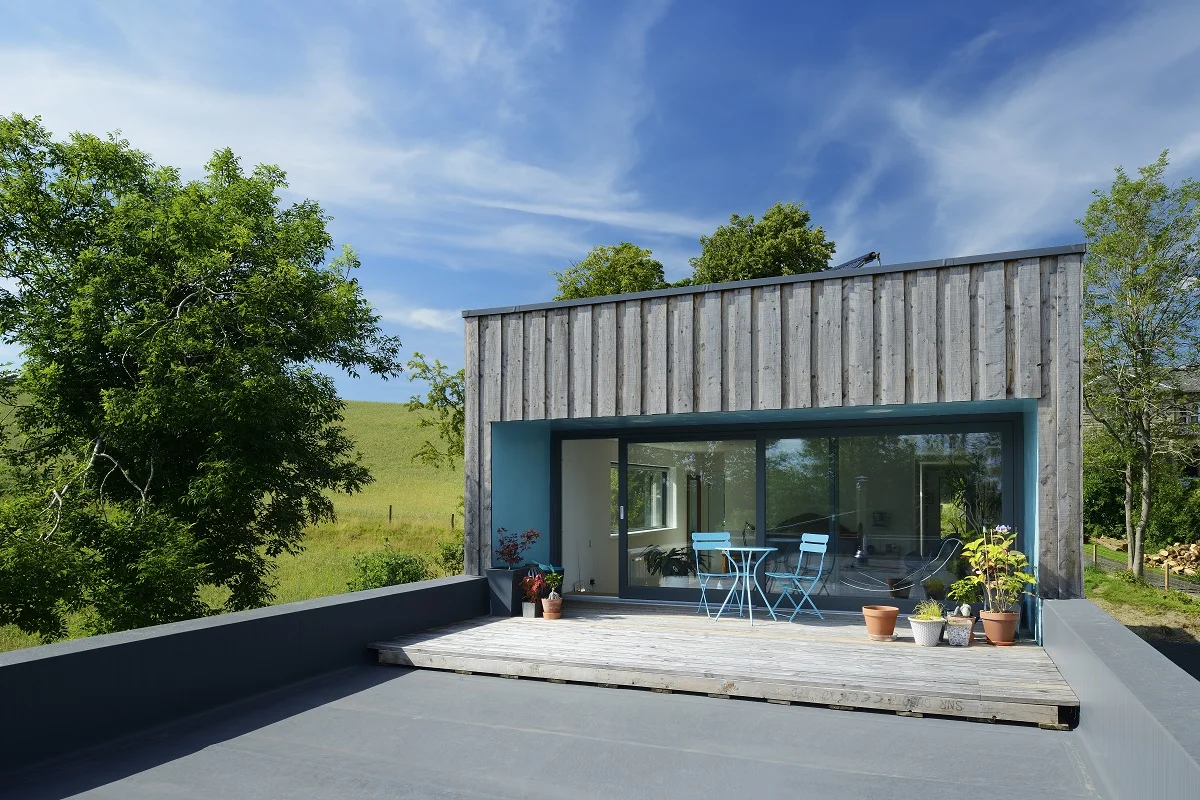 Scotlarch® board-on-board cladding pictured on this house in the hills