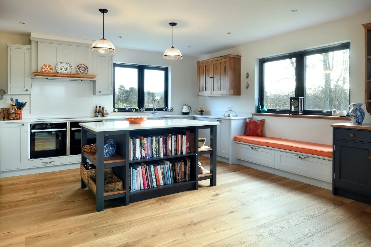 Russwood European Oak Flooring in Honey in a kitchen with an island and a bench.