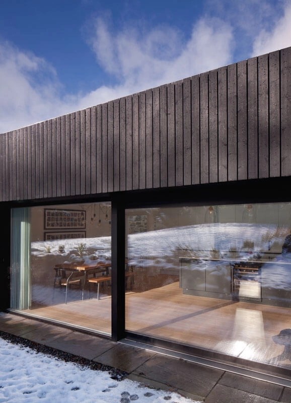 Thermopine® Cladding factory coated in RAL9005 by Staran Architects