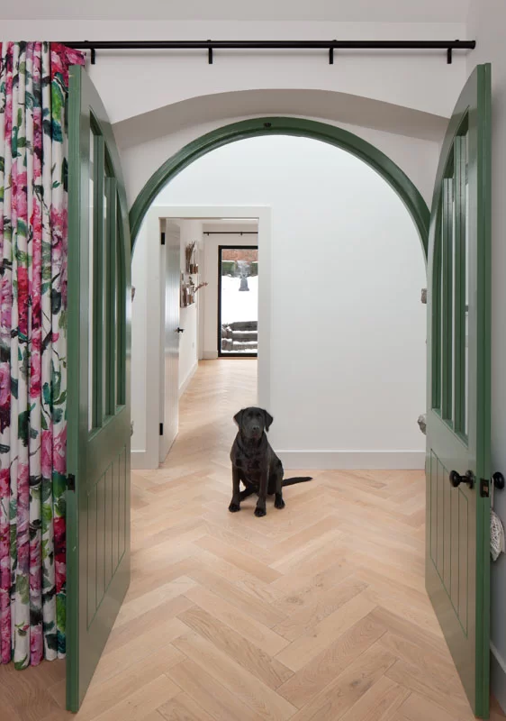 Russwood European Oak Flooring in Pearl used in a project designed by Staran Architects with a black Labrador dog sitting on the floor.