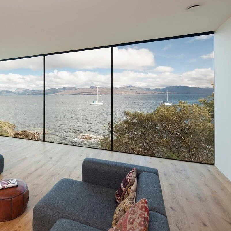 Russwood European Oak Flooring in Natural in a modern living area with a large glass window overlooking the sea.