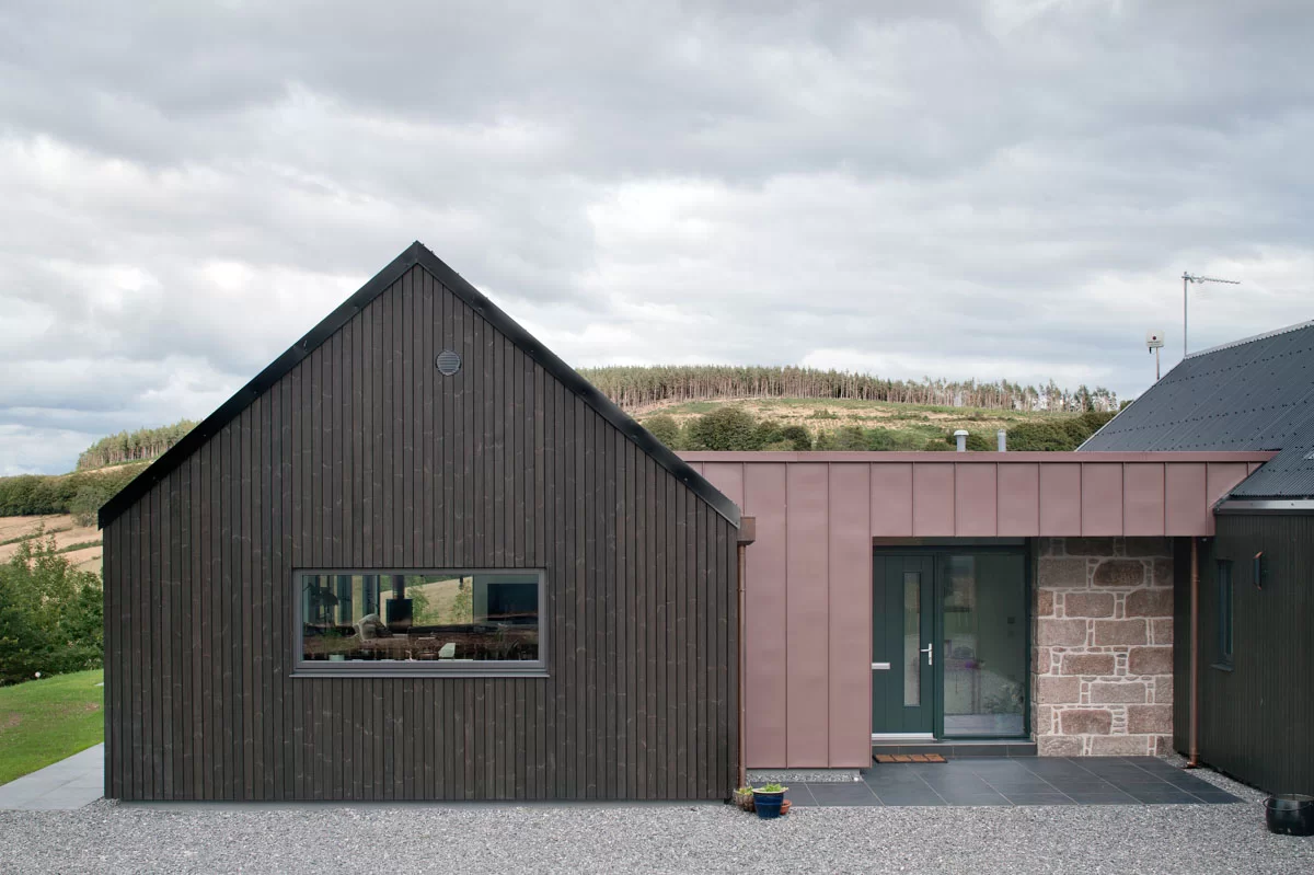 Home clad with Thermopine and a microtex finish factory coated in black paint by Fiddes ArchitectsPhotography