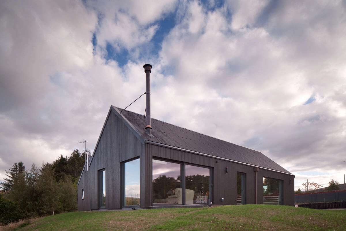 Home clad with Thermopine and a microtex finish factory coated in black paint by Fiddes ArchitectsPhotography