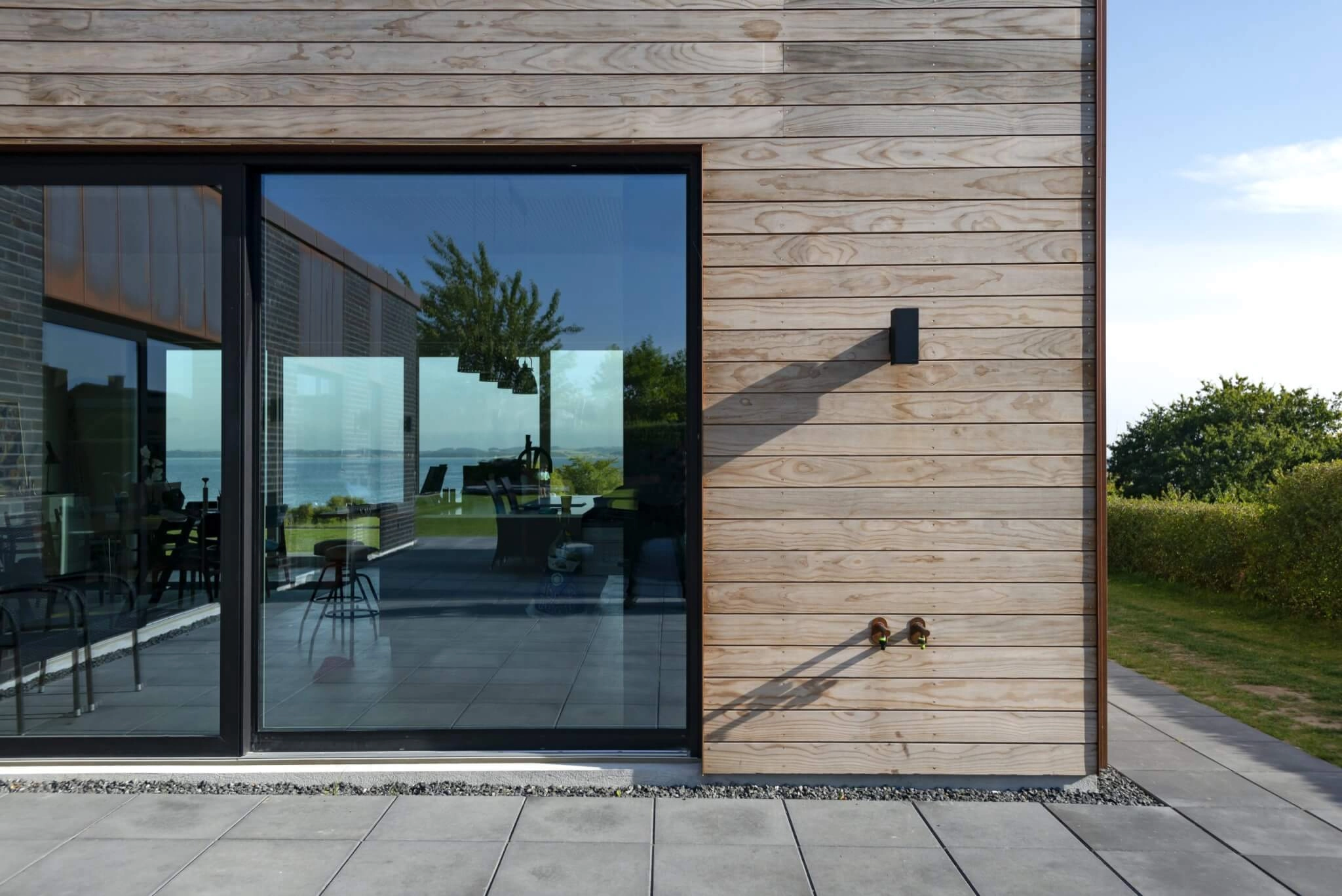 A close up of Imbue™ and a sea view with a glass door.