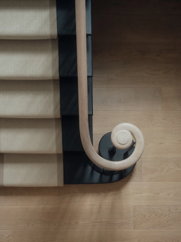 Birds eye shot featuring Russwood oak flooring and a stair runner