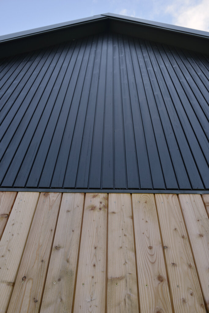 Close up of Kinloch Rannoch Annexe by Eolas Architects showing constrasting timber cladding.