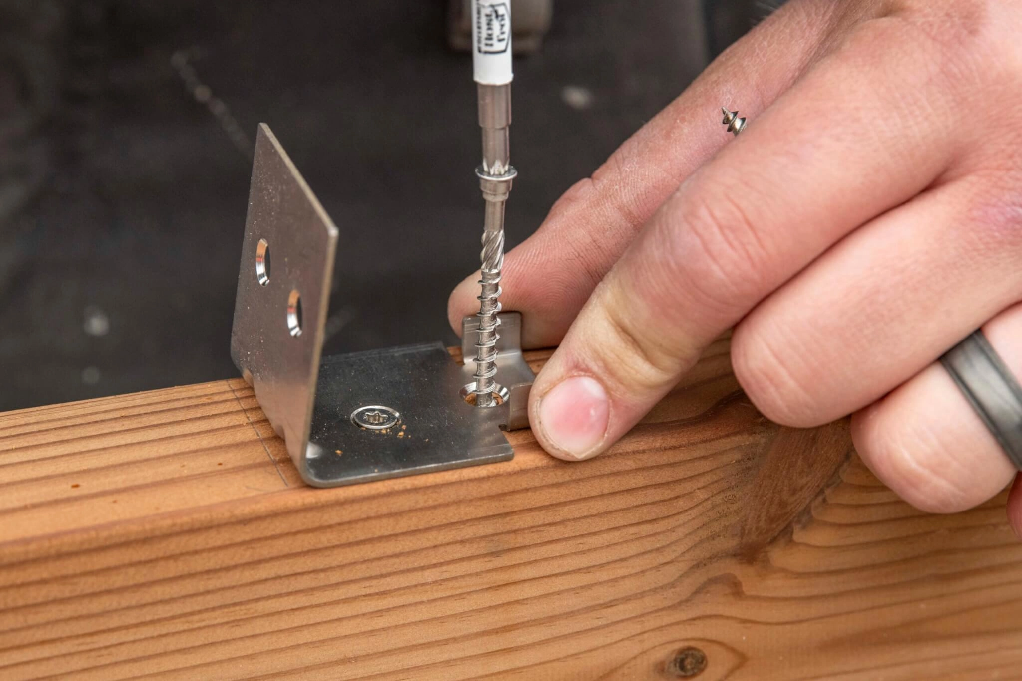 Russwood FinFix® being installed with a screw by a builder.