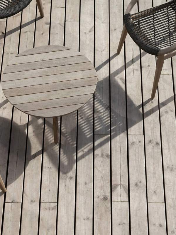 A close up of Russwood's Thermopine decking products weathered to grey