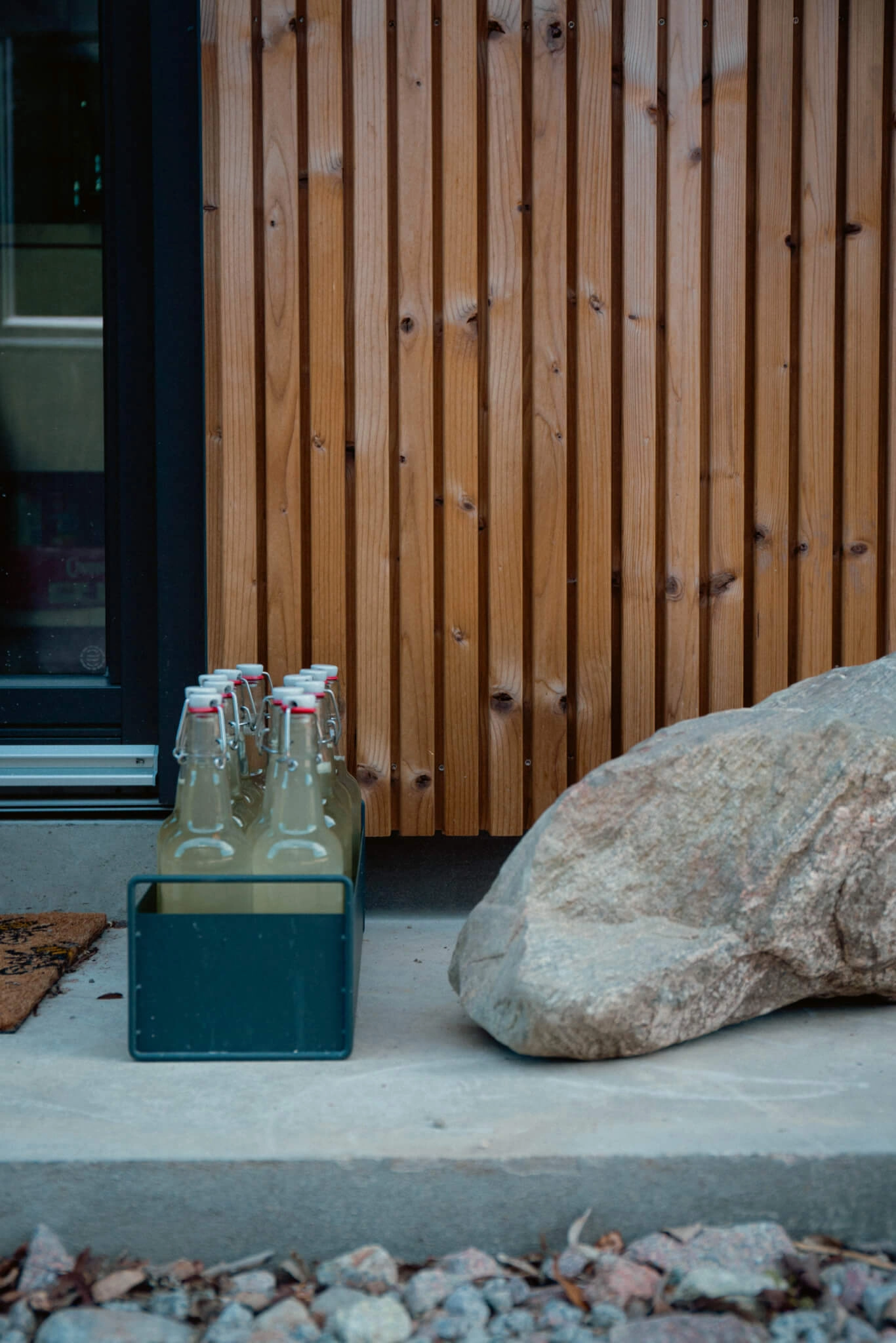 Glass jars sat in front of Lunawood timber cladding